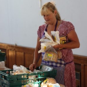 A volunteer distributing food at a food bank