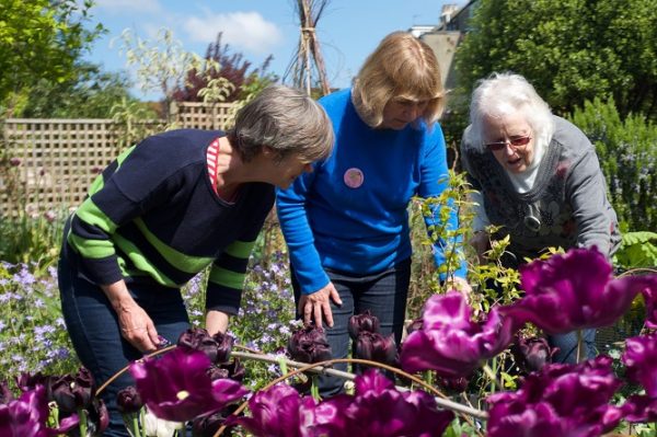 women looking at flowers