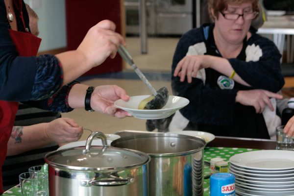 serving up soup bowls to group cookery