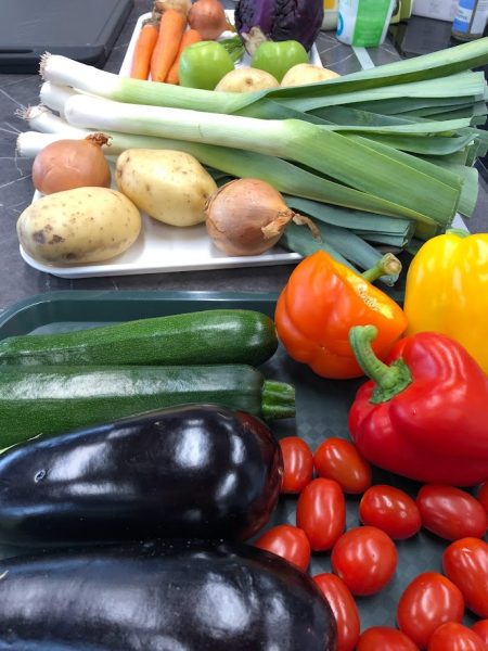 Fresh Vegetables on the kitchen counter including courgettes, peppers, tomatoes and aubergine 