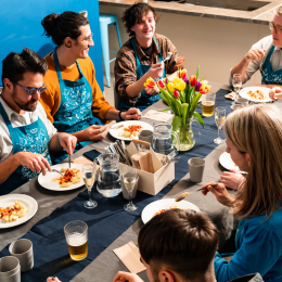 Our newsletters advertise last minute discounts, sales and new releases of our classes in the Community Kitchen. Classes often end like the one in the picture, with a delicious shared meal around our social dining table.