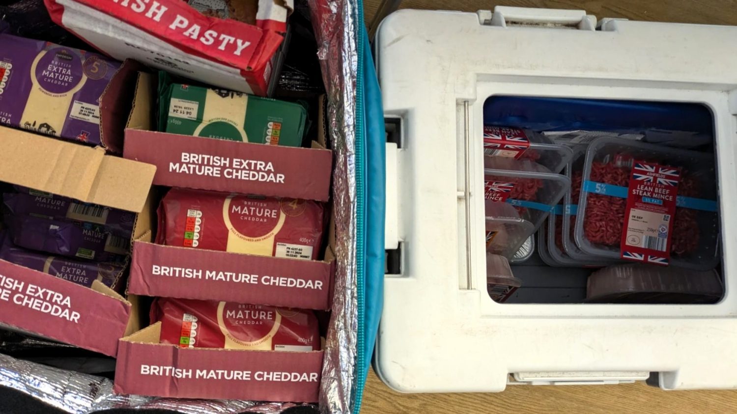 The cool boxes at the Food Shop are full of a variety of packets of cheddar cheese, chicken and beef mince.