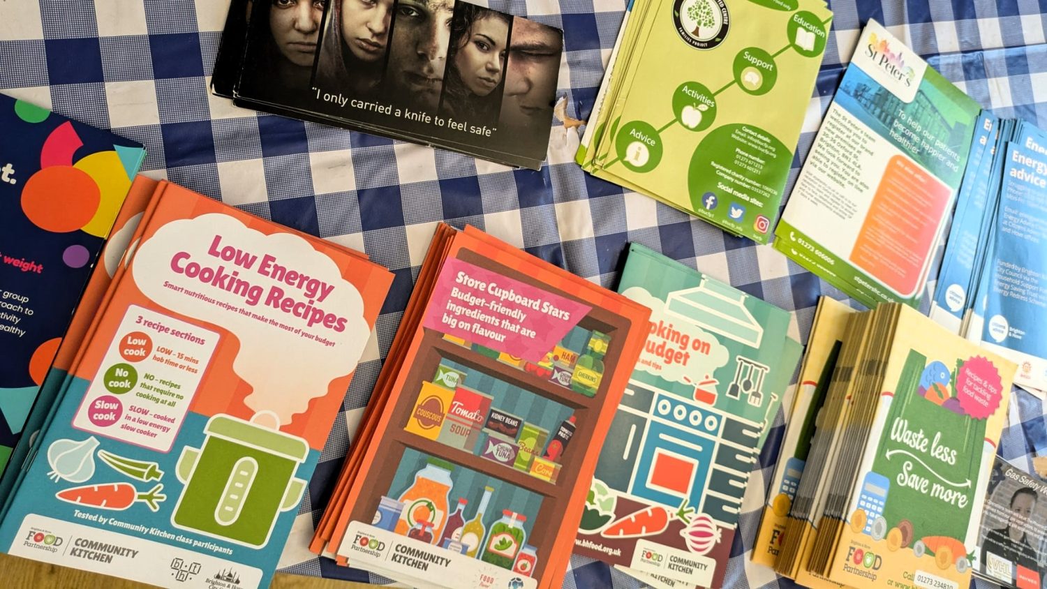 Resources like advice leaflets and recipe books are available on the table for members to take with them.