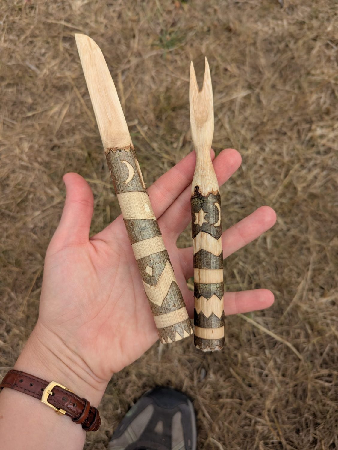 Two beautifully patterned wooden handled implements whittled by participants during the session.